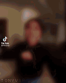 a blurred image of a person 's face with a tiktok watermark