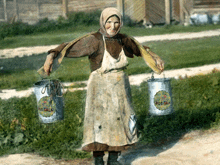 a woman carrying two buckets with pot talk written on them