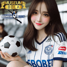 a girl holding a soccer ball in front of an ad for sbobet