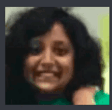 a blurry picture of a woman 's face with a green shirt on