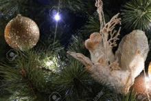 a close up of a christmas tree decorated with decorations and lights .