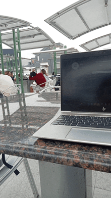 a silver hp laptop sits on a table