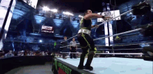 a wrestler in a ring with a monster energy sign