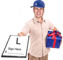 a man in a blue hat is holding a gift and a clipboard that says sign here