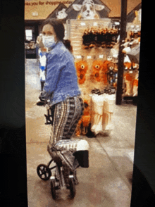 a woman wearing a face mask is riding a scooter in a store