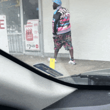 a man walking in front of a store with a sign that says $ 749