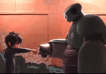 a little boy is pointing at a robot .
