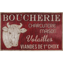 a red sign that says boucherie with a cow on it