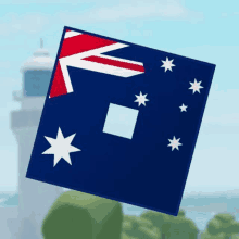 a square with a flag on it is floating in the air in front of a lighthouse .