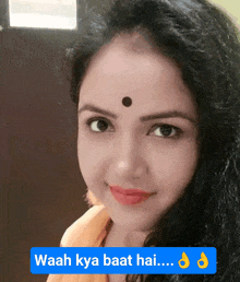 a woman with a bindi on her forehead is smiling with the words waah kya baat hai below her