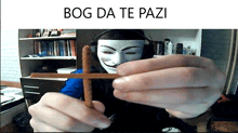 a man wearing headphones and a mask holds a wooden cross with the words bog da te pazi on the bottom