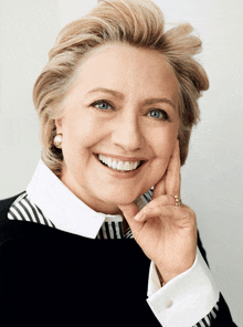 a woman wearing a black and white striped shirt is smiling