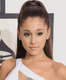 ariana grande is wearing a choker and a ponytail .