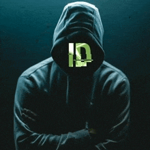 a man in a hoodie with his arms crossed and the letter id on his face .