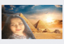 a blurry picture of a woman standing in front of pyramids