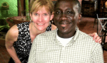 a man and a woman are posing for a picture and smiling