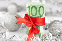 a roll of 100 euro notes tied with a red bow