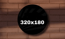 a brick wall with a black circle with 320x180 written on it