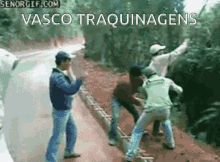 a group of people standing on the side of a road with the words vasco traquinagens written on the bottom