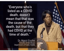 a woman is standing at a podium with a quote from dr. ngozi enzike