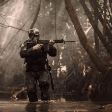 a man in a military uniform is holding a gun in the water