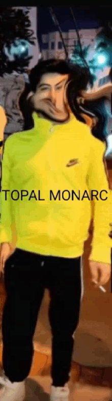 a man wearing a neon yellow nike sweatshirt with the word topal monarch written on the front