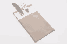 a knife and fork in a napkin holder with a white border