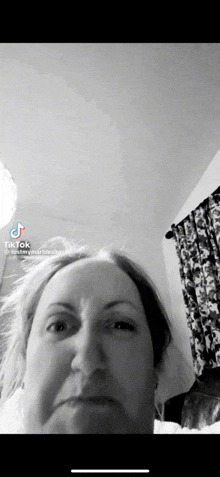 a woman is making a funny face in a black and white photo with tiktok written on the bottom right