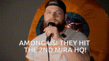 a man singing into a microphone with the words " among us they hit the 2nd mira hq "