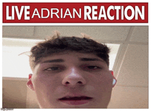 a man 's face is shown in front of a sign that says " live adrian reaction "