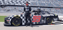 a man stands next to a race car with the number 99 on it