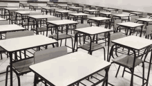 there are a lot of tables and chairs in this classroom .