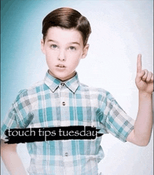 a young boy in a plaid shirt is pointing up with the words couch tips tuesday written below him