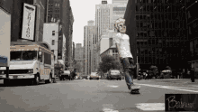 a man wearing a mask is riding a skateboard down a city street in front of a sign that says shivago