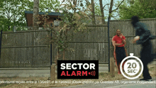 a man in a red shirt stands in front of a fence with a sign that says " sector alarm "