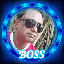 a man wearing sunglasses and a red shirt with the word boss on it