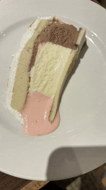 a white plate topped with a slice of cake with ice cream on it