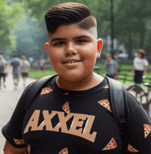 a boy wearing a black shirt with axxel on it