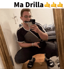 a man taking a selfie in front of a mirror with the words ma drilla on the bottom