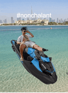 a man is sitting on a sea doo jet ski in the ocean