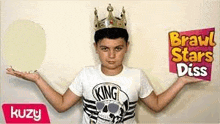 a young boy wearing a crown and a skull t-shirt is holding a sign .