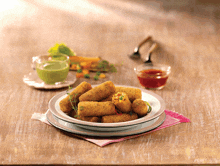 a plate of food on a table with a bowl of green sauce