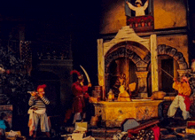 a group of pirates are standing in front of a building with a balcony