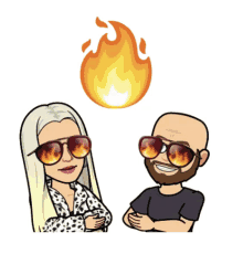 a man and a woman wearing sunglasses are standing next to each other with a fire behind them