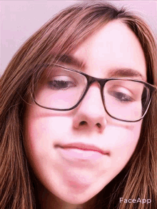 a close up of a girl wearing glasses with faceapp written on the bottom right