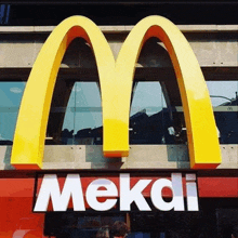 a large mcdonald 's sign with the word meksi underneath