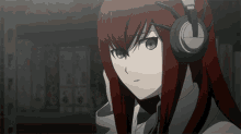 a girl with red hair wearing headphones looks serious