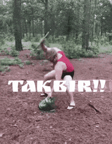 a woman in a red tank top is standing in the woods with the words takbir written on the bottom