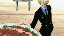 a man in a suit is standing next to a plate of meat