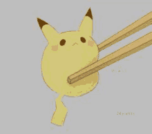 a pikachu with chopsticks in its mouth is eating a piece of food .